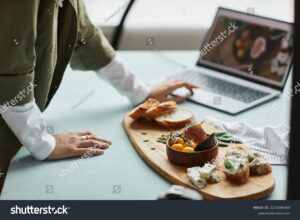 Stock Photo Close Up Of Female Food Photographer Using Laptop While Working In Studio Digital Creator Concept 2133698369